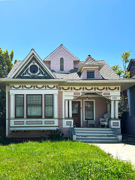 Historic architecture in Los Angeles seen in a pink Victorian home in Angelino Heights, with ornate trim and a romantic facade.
