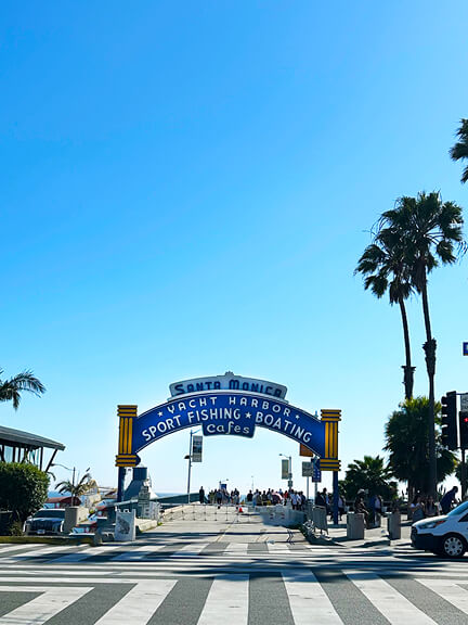 Historic architecture in Los Angeles captured in the iconic blue and yellow sign at the entrance to the Santa Monica Pier.