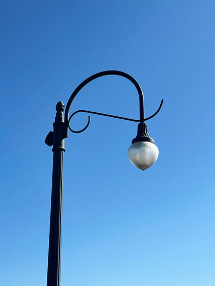 Curved street lights with sinuous Art Deco lines at Santa Monica Pier, capturing the vintage character of this iconic LA boardwalk. Curved street lights with sinuous Art Deco lines at Santa Monica Pier, capturing the vintage character of this iconic LA boardwalk.