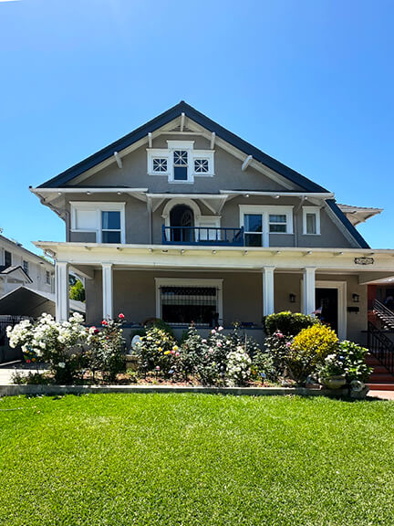 Historic architecture in Los Angeles shown in a Craftsman-style home on Van Buren Place in West Adams, with wood trim and deep eaves.