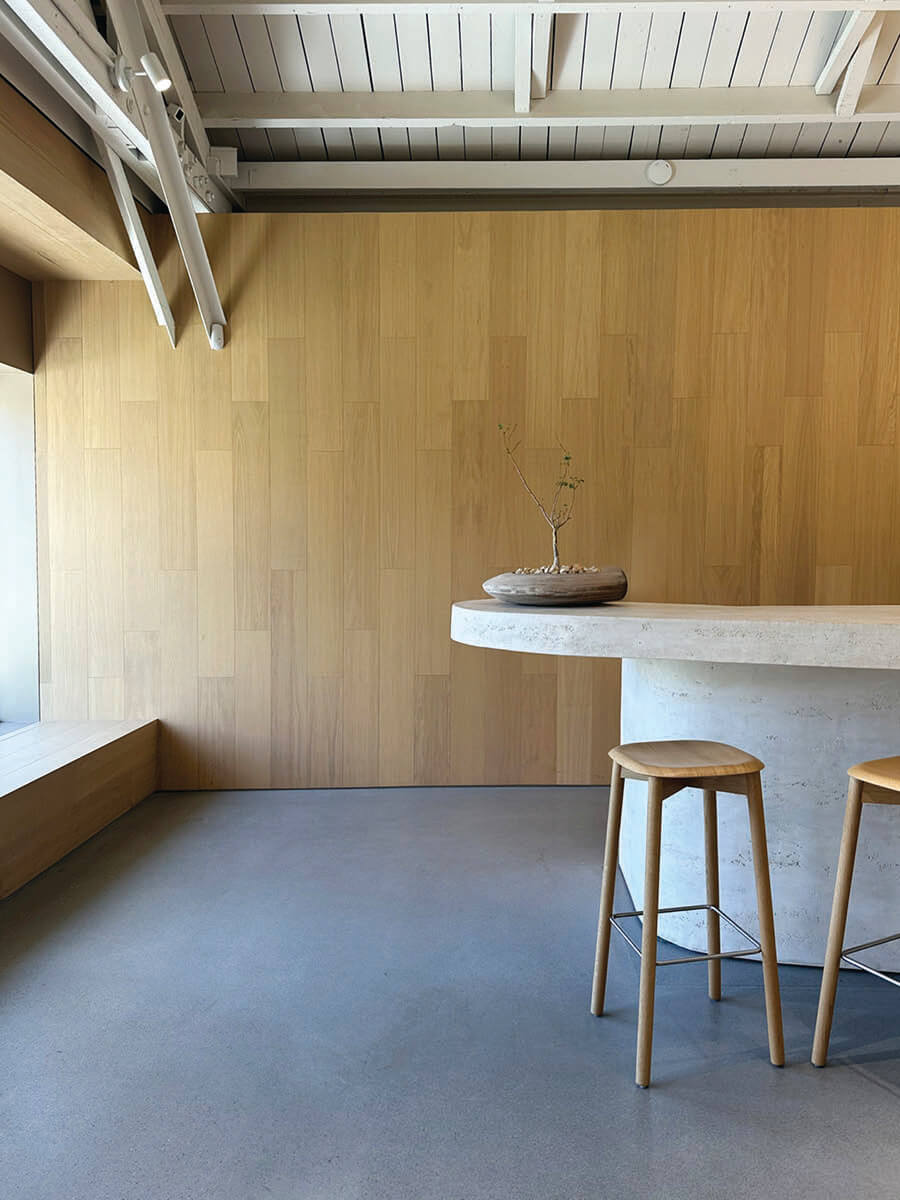 Wood veneer walls and concrete floors in Armadillo showroom with minimalist design