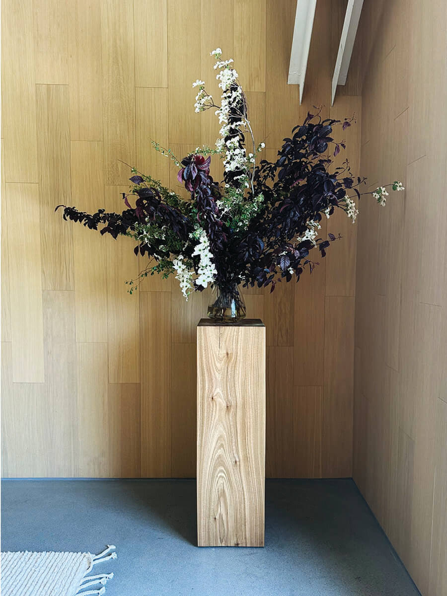Wood veneer walls with sculptural planter in LA interior design showrooms